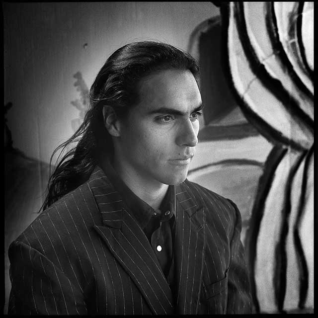 Well dressed man with long black hair - based on the Loteria card