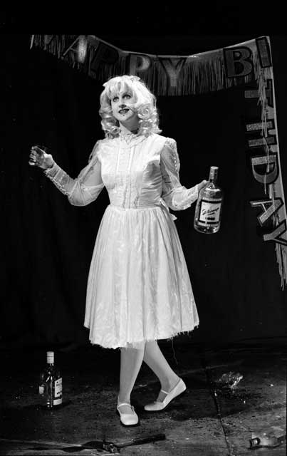 A crazy lady holding a bottle of booze