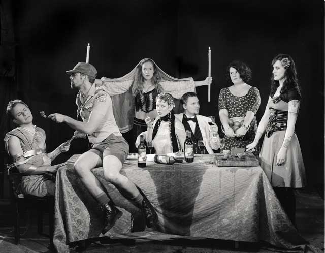 A group of people at a table having a disasterous holiday dinner