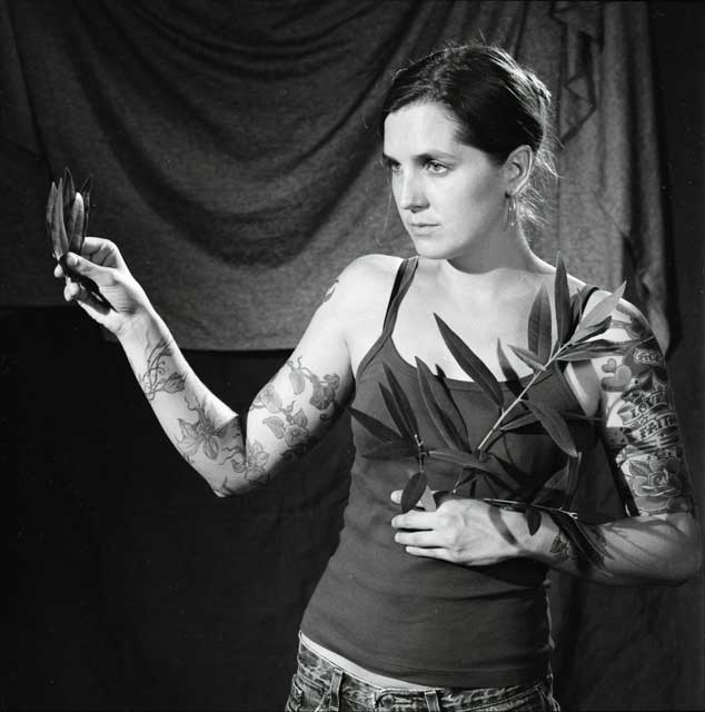 Tattooed oracle bearing a sprig from a bay tree